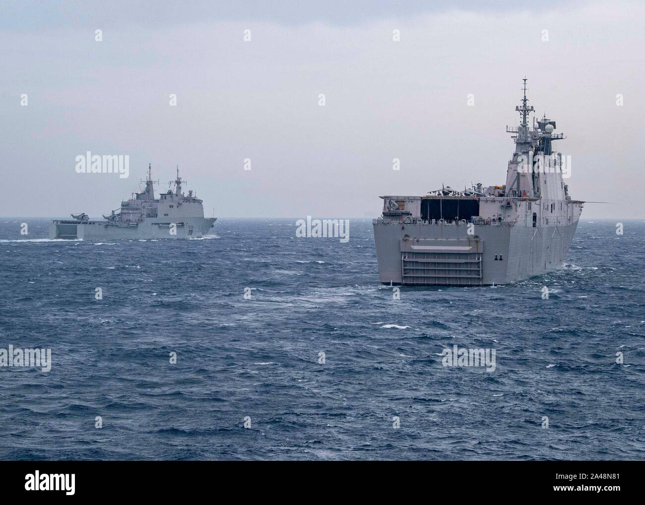 191011-N-UB406-0197  GULF OF CADIZ (Oct. 11, 2019) The Spanish navy amphibious assault ship-aircraft carrier ESPS Juan Carlos (L-61), right, and the Spanish navy replenishment oiler ESPS Cantabria (A 15), left, transit the Gulf of Cadiz with NATO Allied forces as part of exercise Dynamic Mariner 2019 as seen from the U.S. Navy guided-missile destroyer USS Gridley (DDG 101). The NATO Maritime Command-led Dynamic Mariner/Flotex 19 (DYMR/FL19) is an exercise that tests NATO's Response Force Maritime Component and enhances the flexibility and interoperability amongst Allied nations. DYMR/FL19 invo Stock Photo