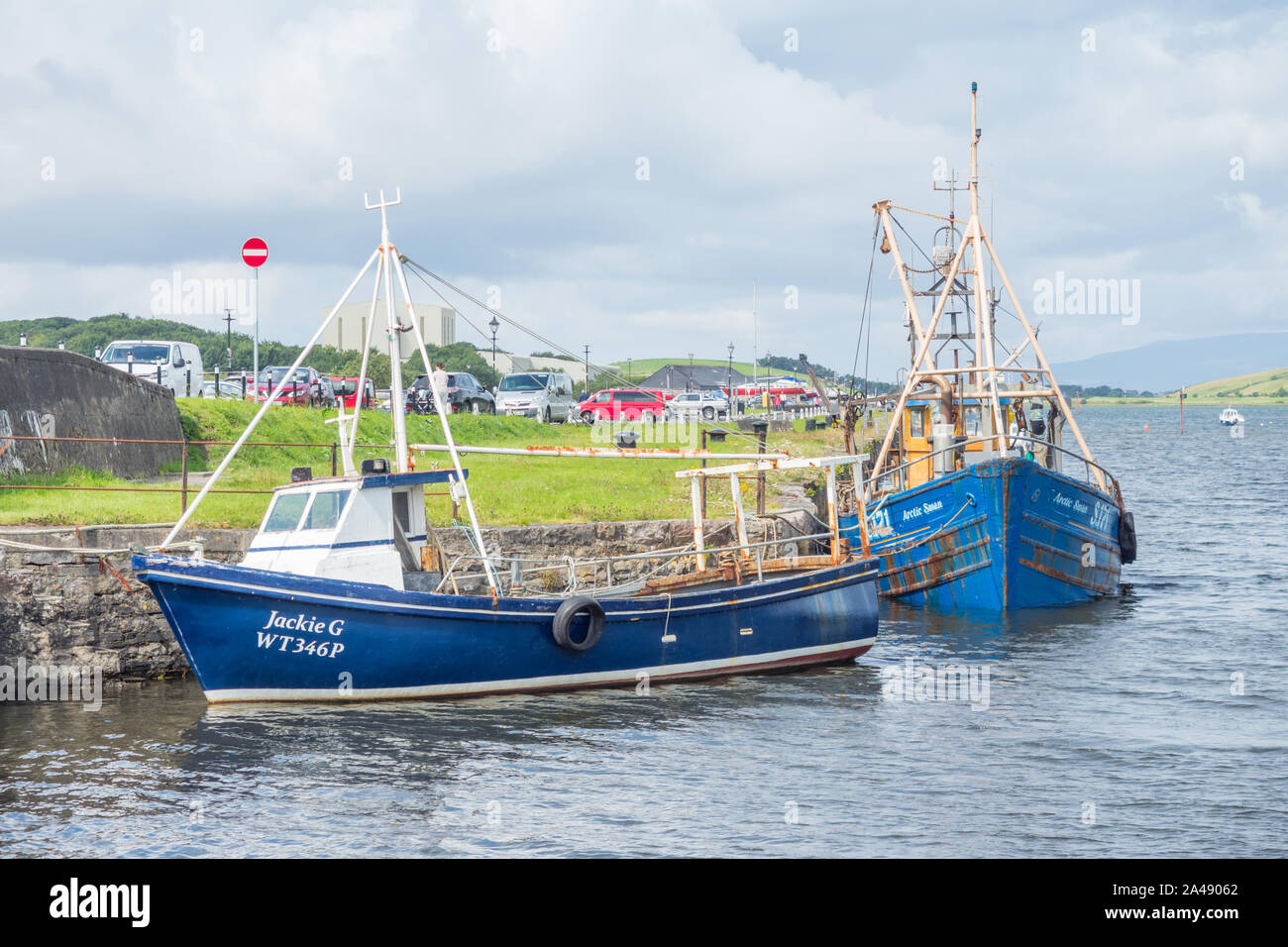 WESTPORT, IRELAND - AUGUST 7, 2019: Fishing boats lined up at Westport Harbour in County Mayo, Ireland. Stock Photo