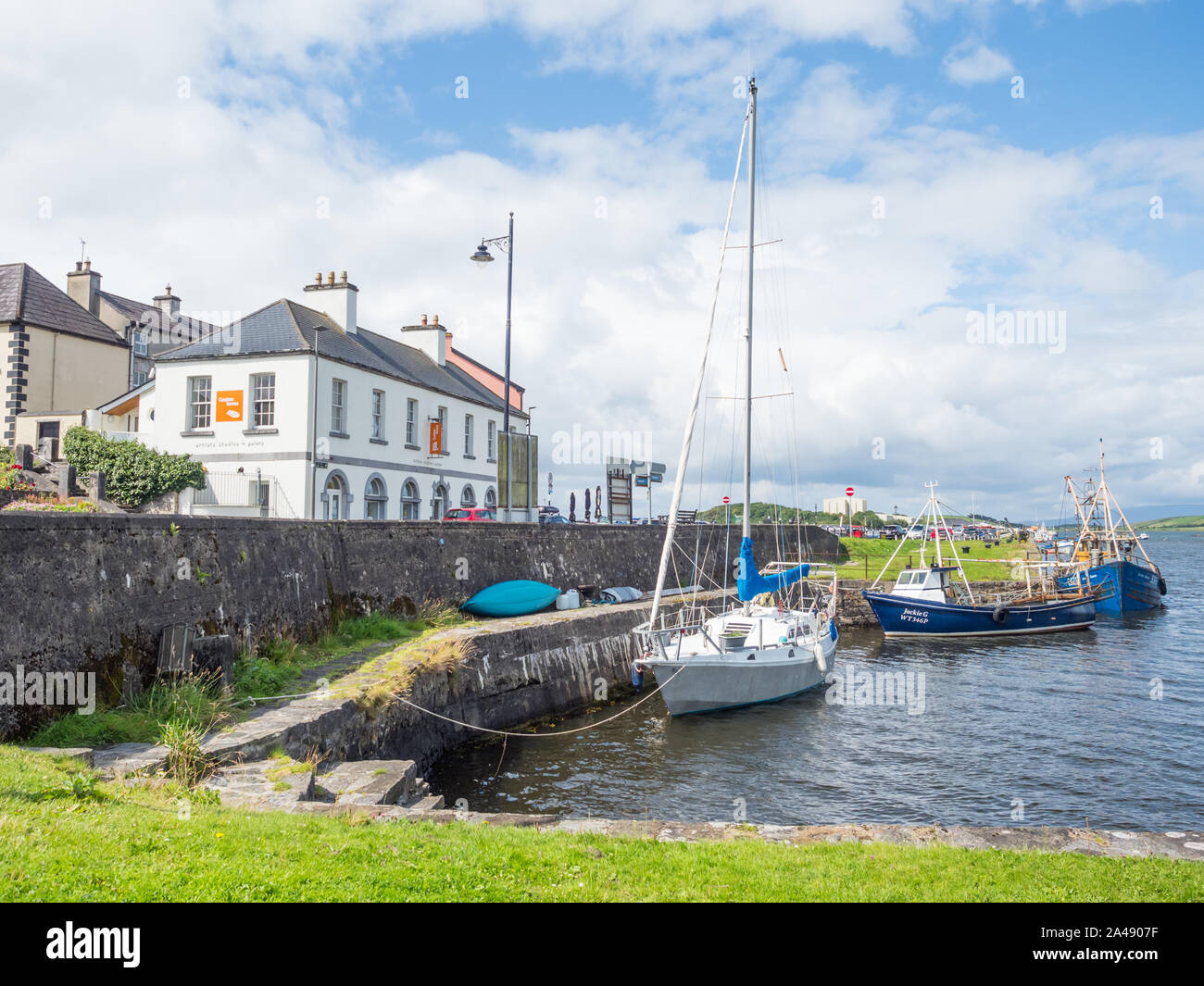 WESTPORT, IRELAND - AUGUST 7, 2019: Boats lined up at Westport Harbour in County Mayo, Ireland. Stock Photo