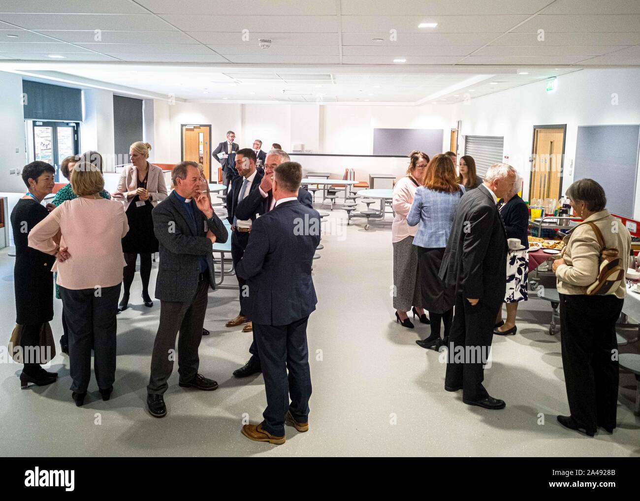 Members of Clacks Council, Local government and businesses are seen conversing in the dining hall during the opening ceremony.Clackmannanshire Council and local members of government and business officially opened the new £15m state of the art primary school and nursery for both Abercrombie Primary and St Bernadette RC Primary and Tulach Nursery to replace the old, aging buildings. The building, Tullibody South Campus hosts the 2 schools, nursery and local library. The building was opened by Depute leader of the Scottish National Party and Clackmannanshire and Dunblane MSP Keith Brown. Stock Photo