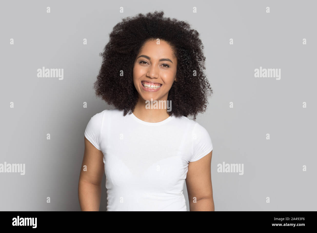 Positive african American girl look at camera posing in studio Stock ...