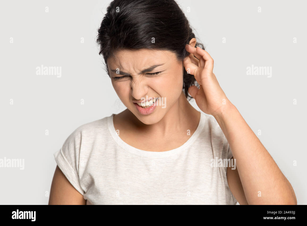 Unhappy indian girl annoyed by loud noise Stock Photo