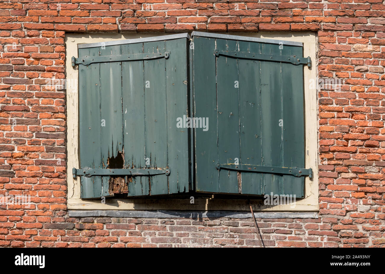 Vintage wooden shutters close the window in a stone brick wall Stock ...