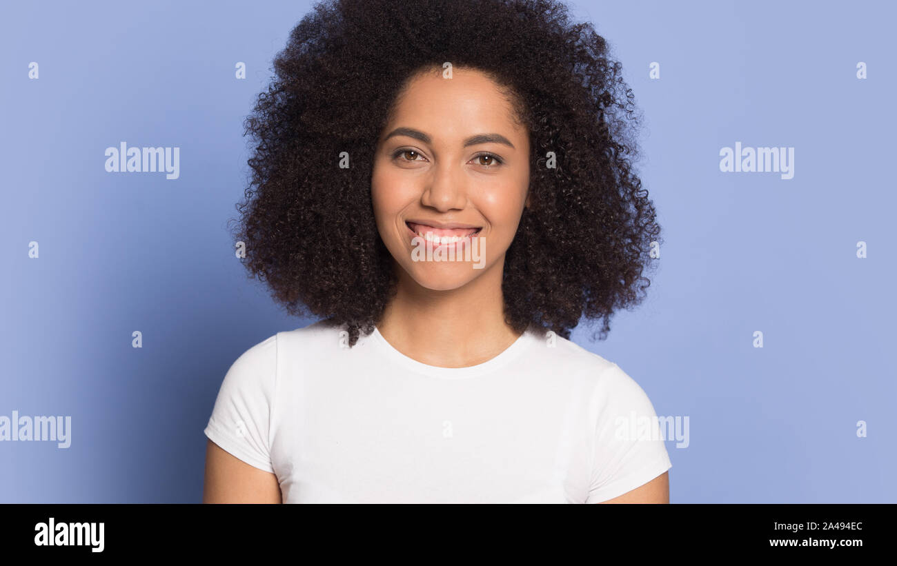 Portrait of smiling biracial young woman look at camera Stock Photo