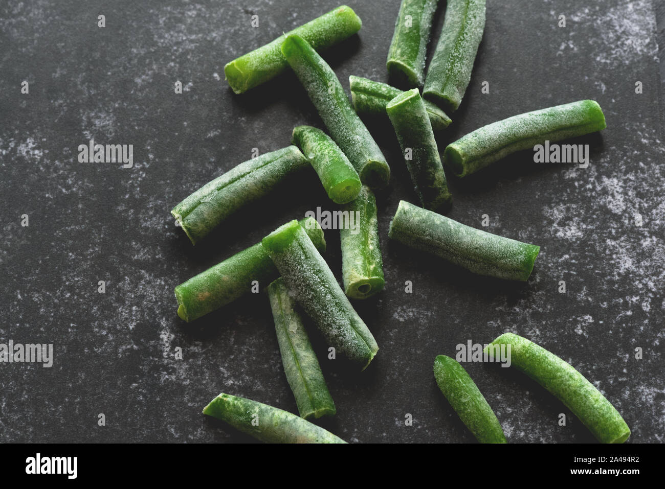 Green beans on a stone cutting board background. Stock Photo