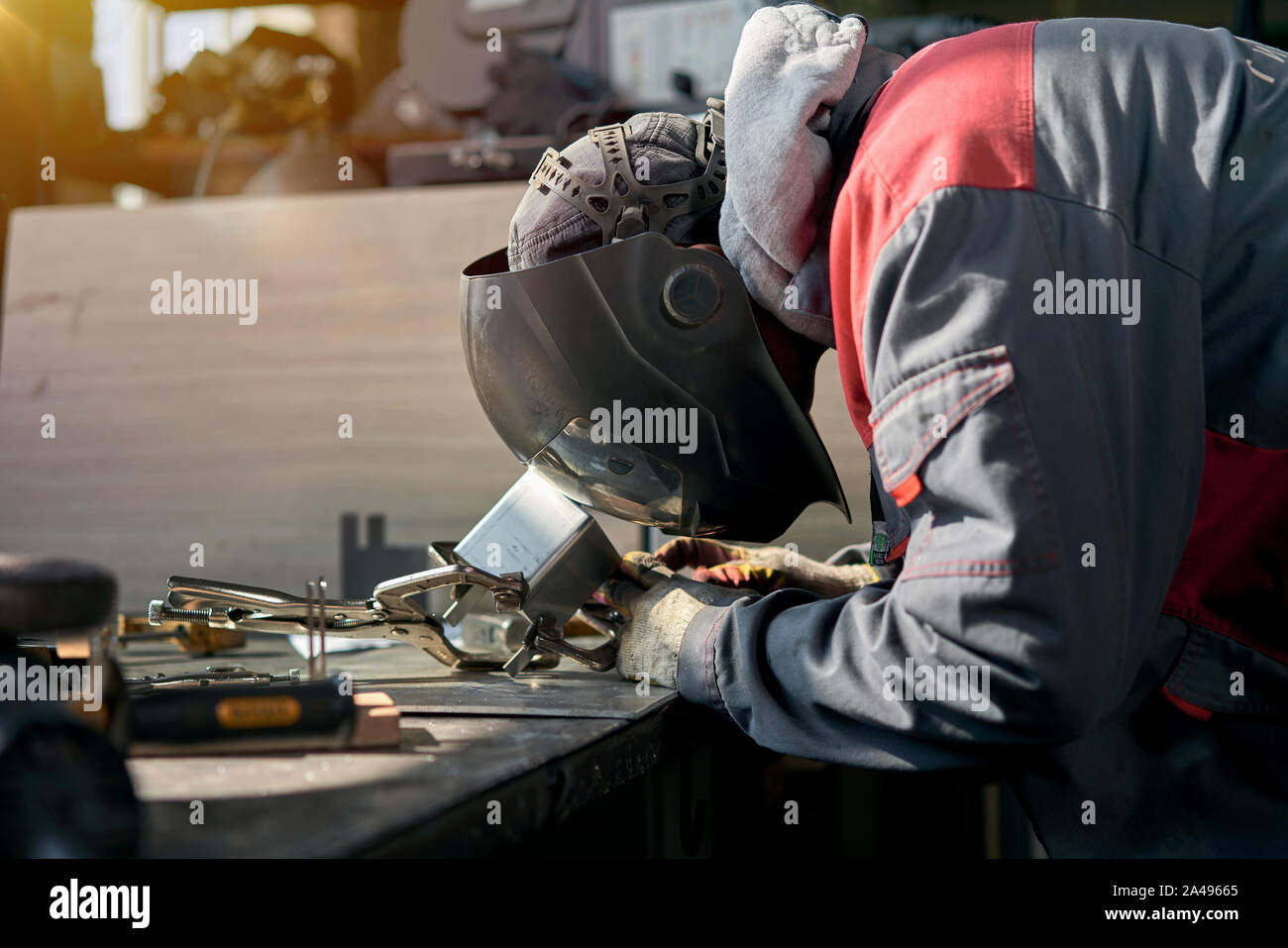 man in overalls working with welding Stock Photo