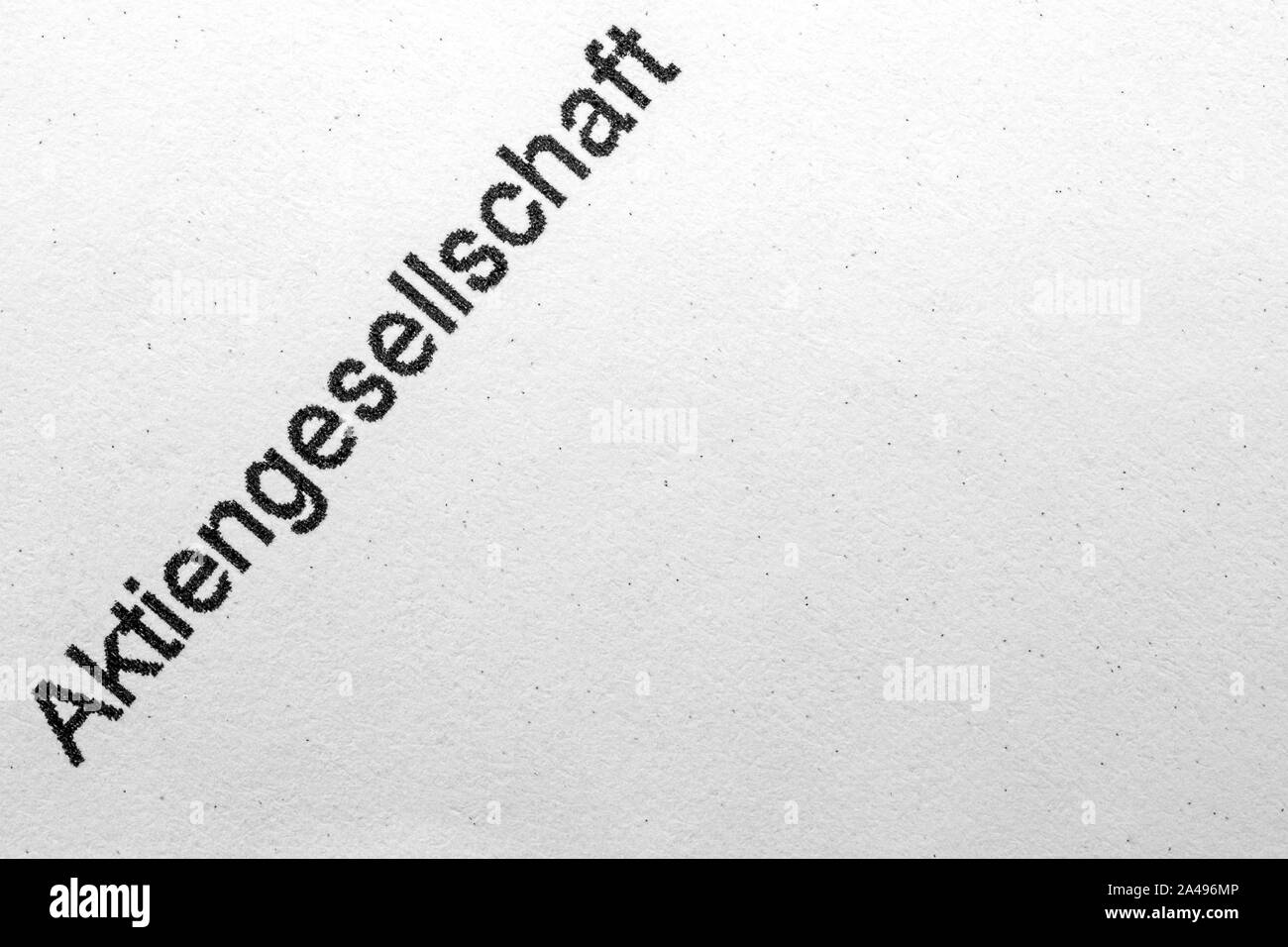 the german word Aktiengesellschaft written on white paper, translation joint-stock company Stock Photo