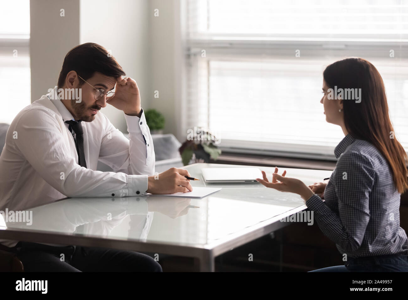 Confused male hr manager listening to female job applicant. Stock Photo