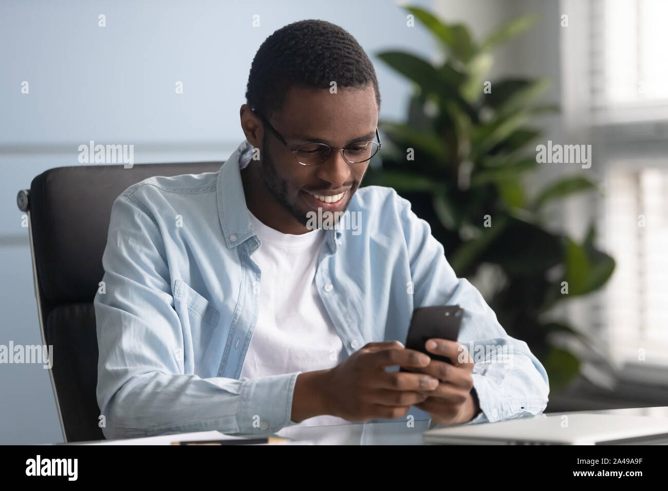 Application Use Employees Smiling african american employee using mobile applications Stock Photo ...