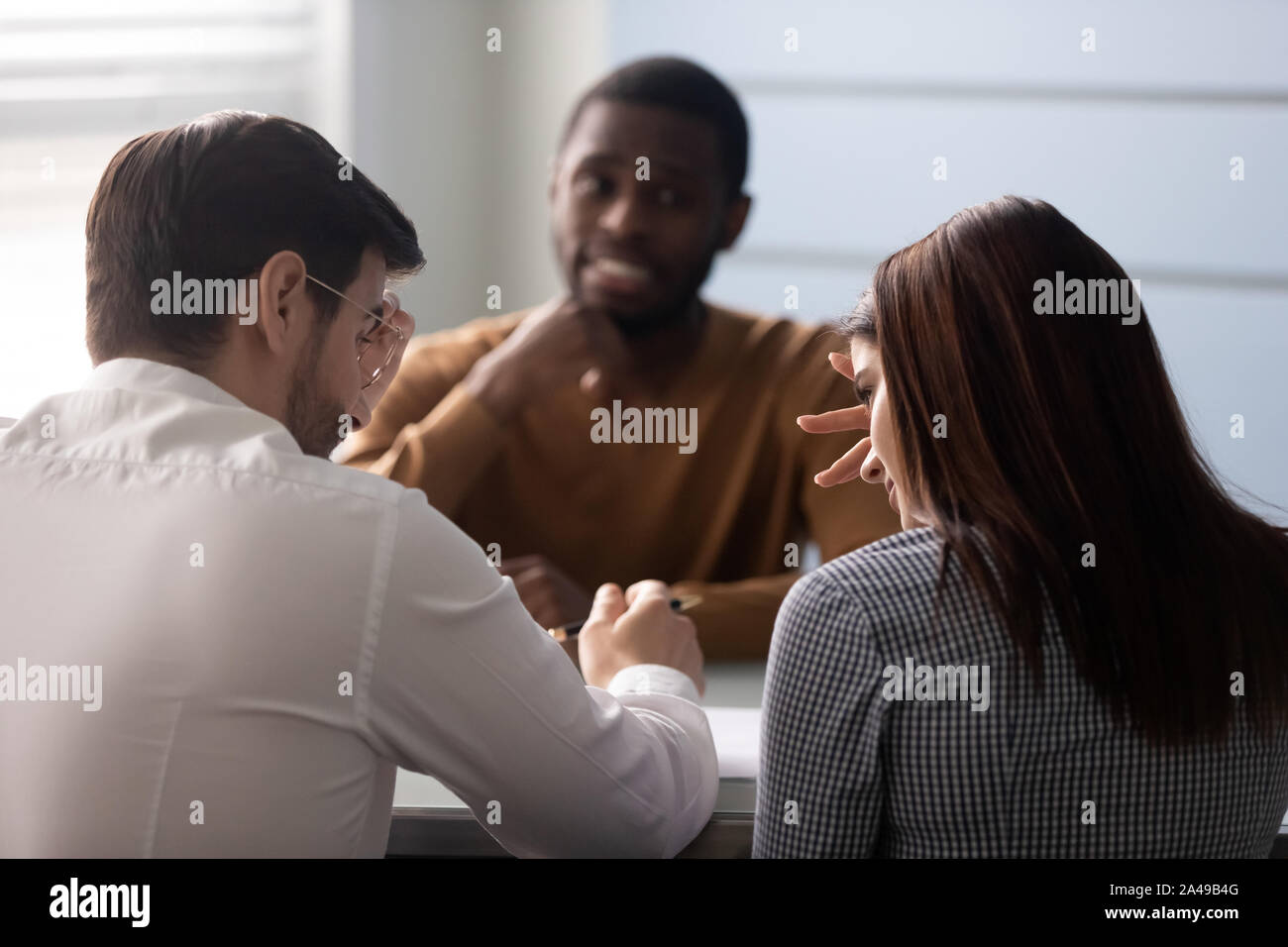 Doubtful clients unsure about purchase propose of advisor. Stock Photo