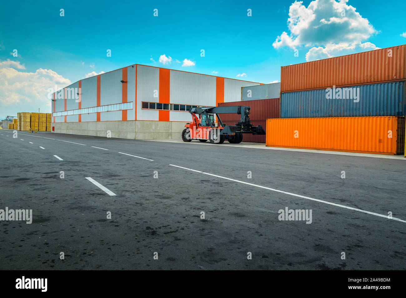Shipping yard and colorful cargo shipping containers with crane. Container yard with containers box and import export business concept Stock Photo