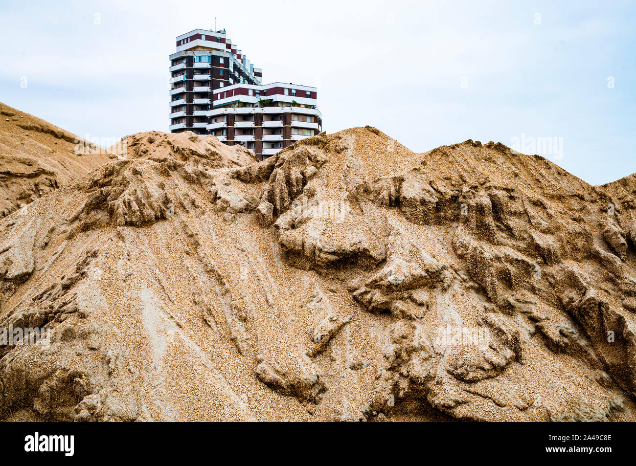 sand and two buildings in the background Stock Photo - Alamy