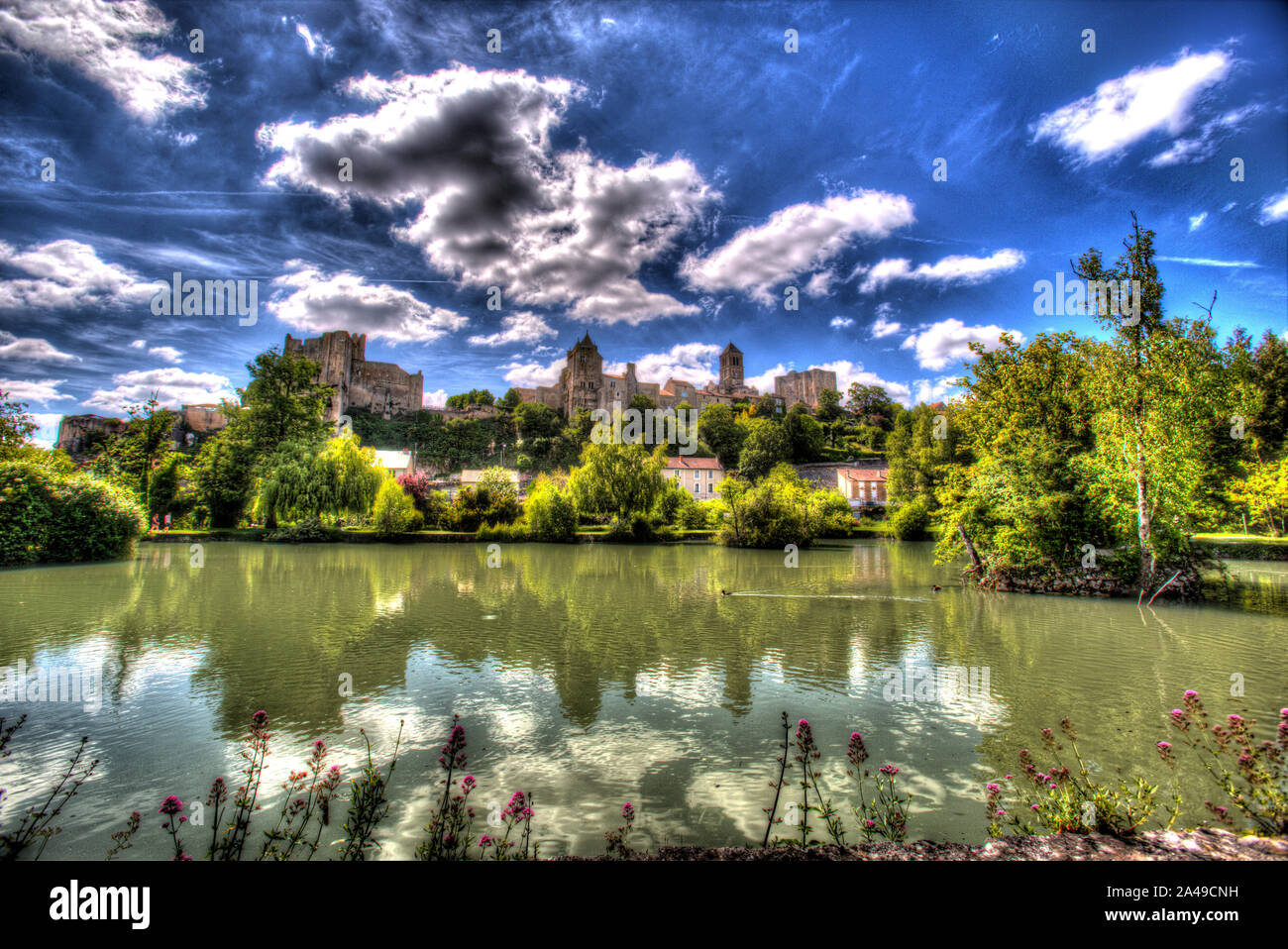 Chauvigny, France. A lake in a public garden with the Baronial Castle ruins, Donjon de Gouzon and Chateau d’Harcourt in the background. Stock Photo