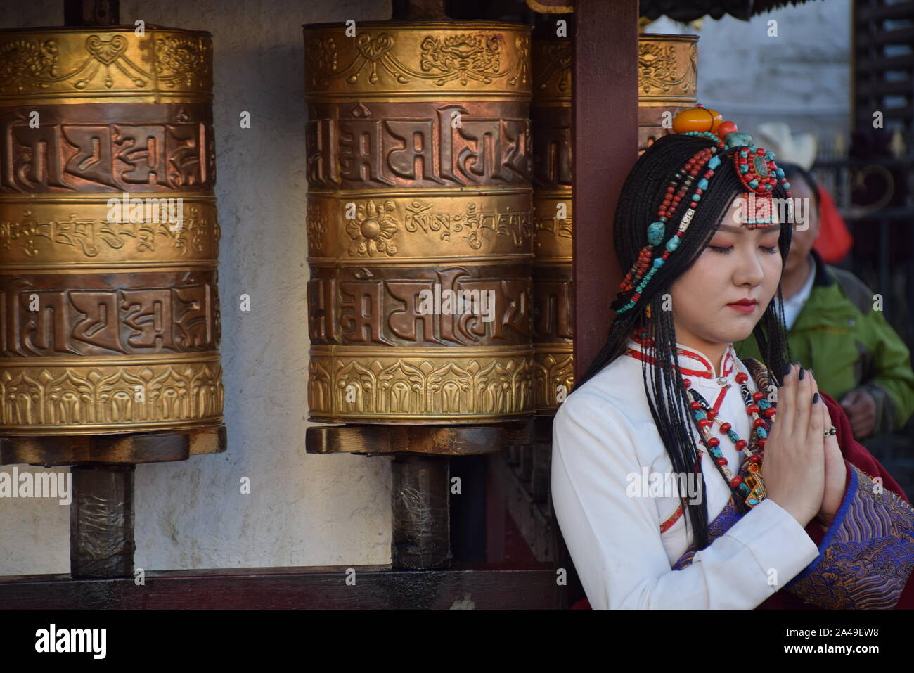 Beautiful asian girl taking photo shoot dressed with traditional tibetan clothes in Barkhor street, Lhasa - Tibet Stock Photo