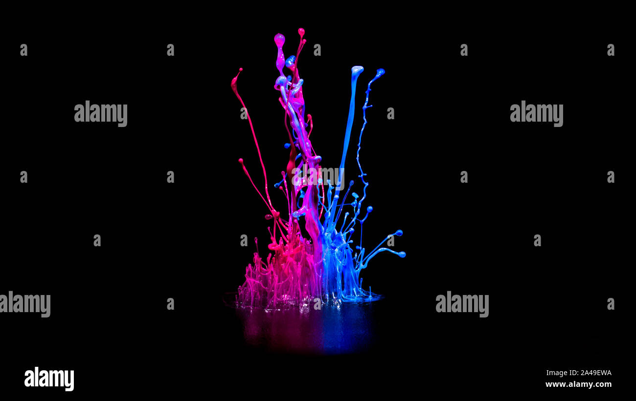 Pink and bluel paint splashing on audio speaker isolated on black background Stock Photo