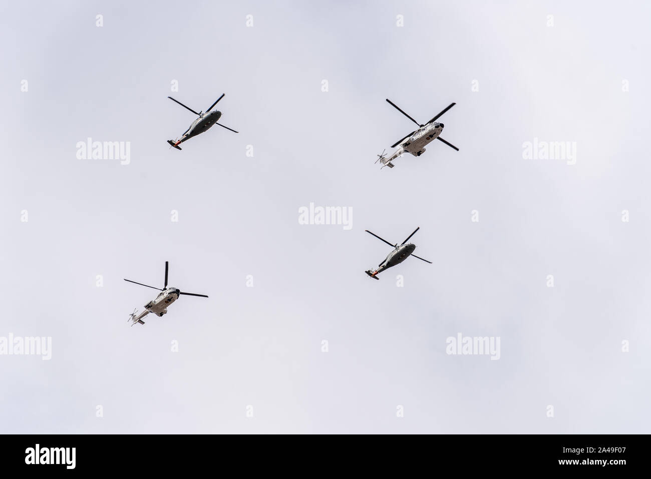 Madrid, Spain - October 12, 2019: Two Eurocopter AS332 Super Puma and two Sikorsky S-76 Spirit helicopters flying in formation during Spanish National Stock Photo