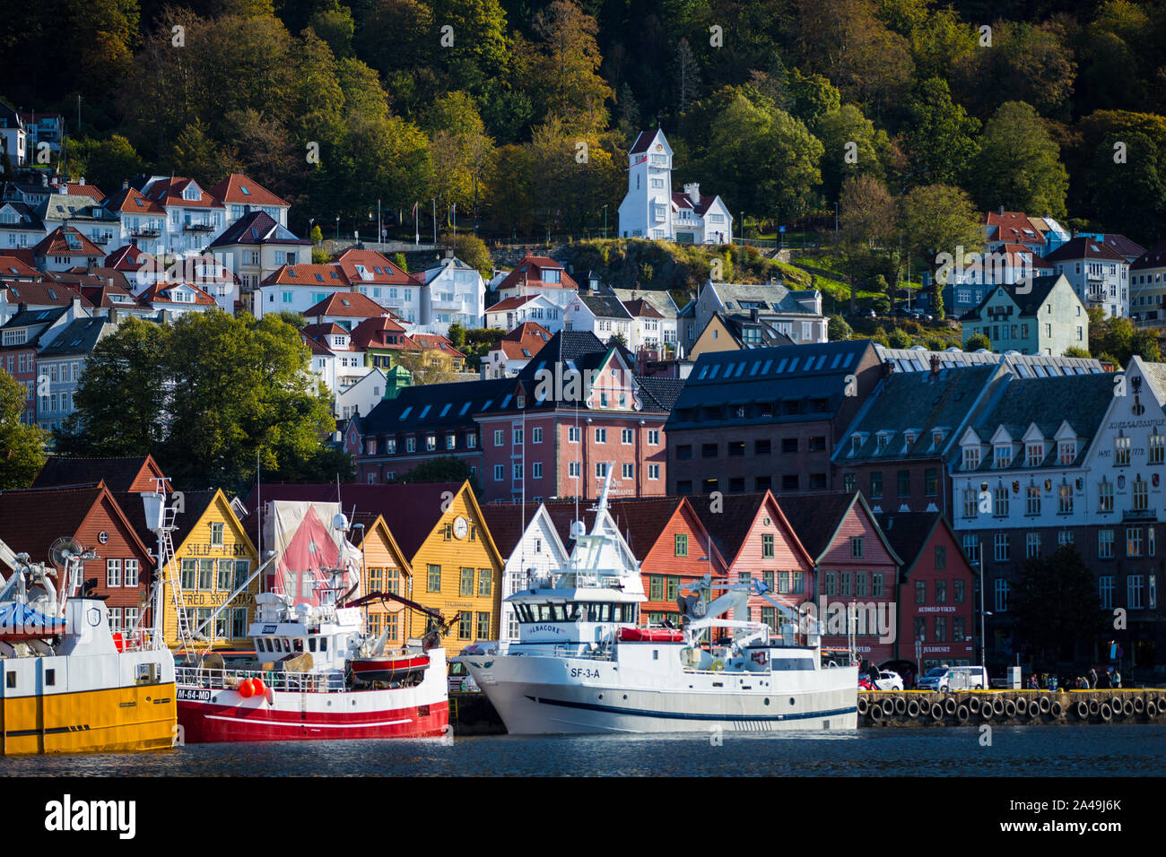 Houses on a hillside and boats in the harbour Bergen, Norway Stock Photo