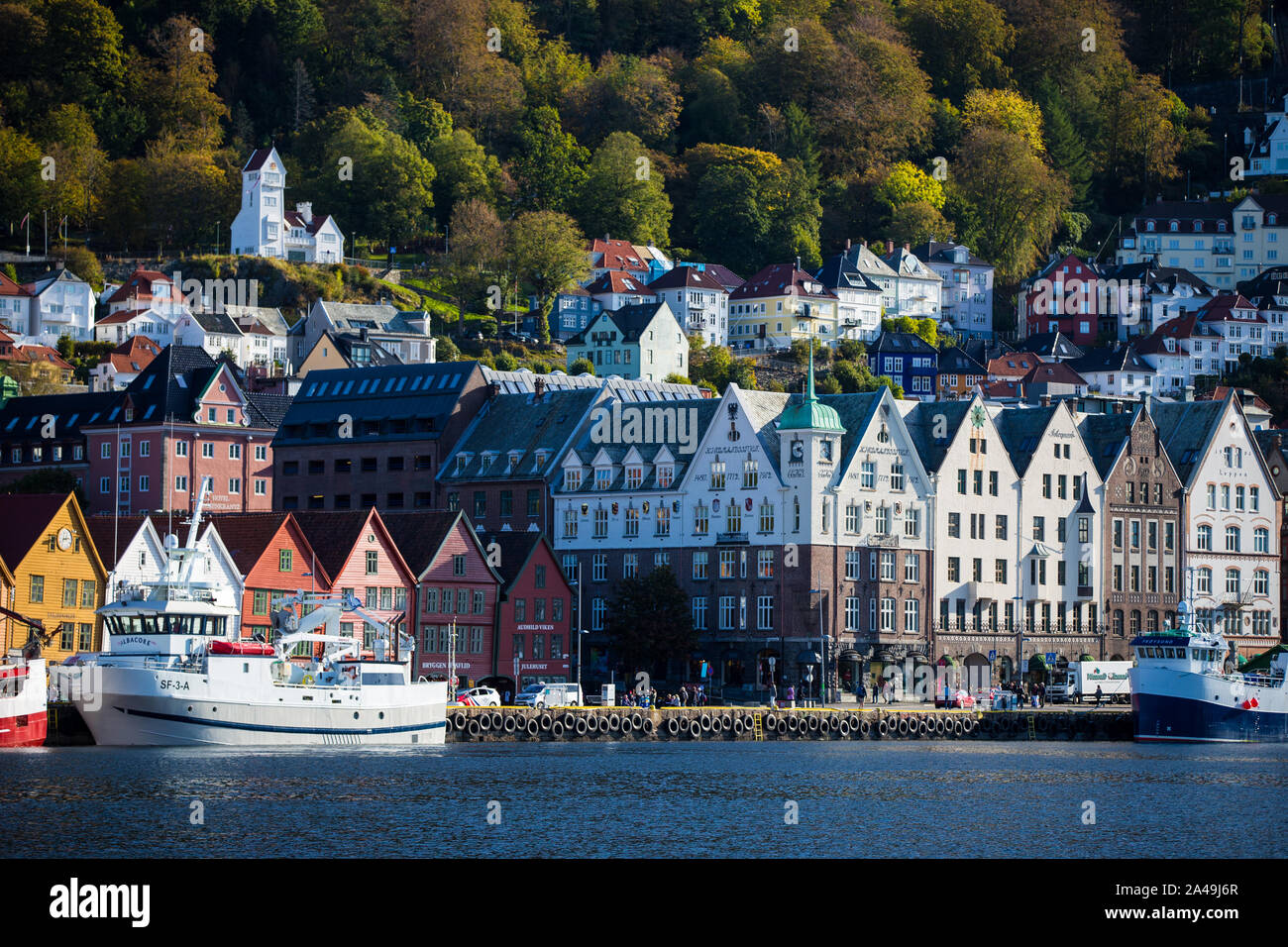 Houses on a hillside and boats in the harbour Bergen, Norway Stock Photo