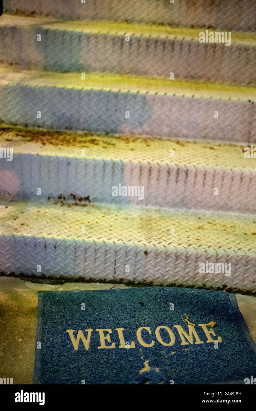 Mat at the entrance, dirty old worn and worn to holmes, blue