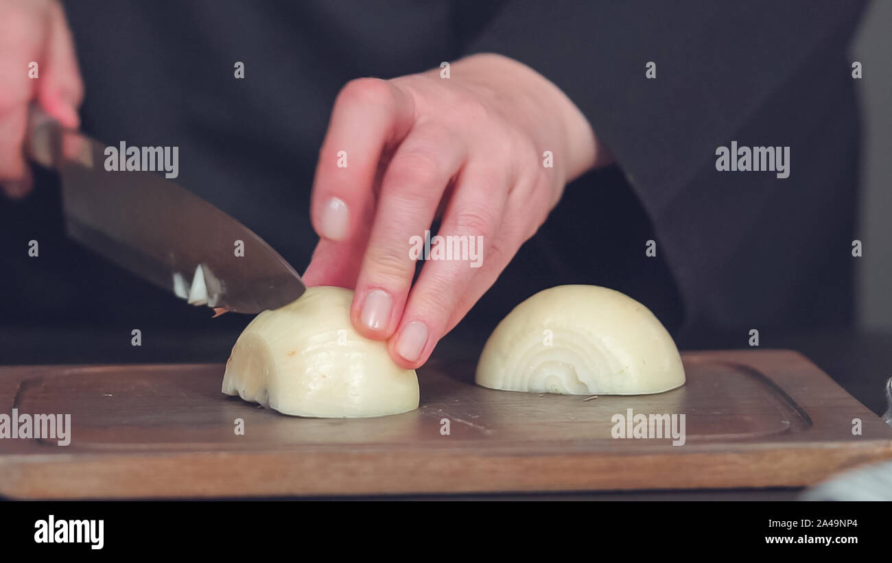 Step by step. Dicing yellow onion on a wood cutting board Stock Photo ...