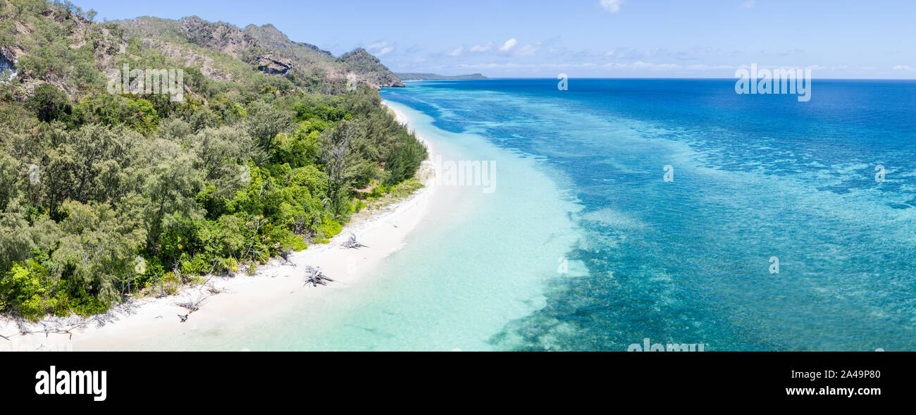 A remote tropical island in the Banda Sea is surrounded by seagrass and ...