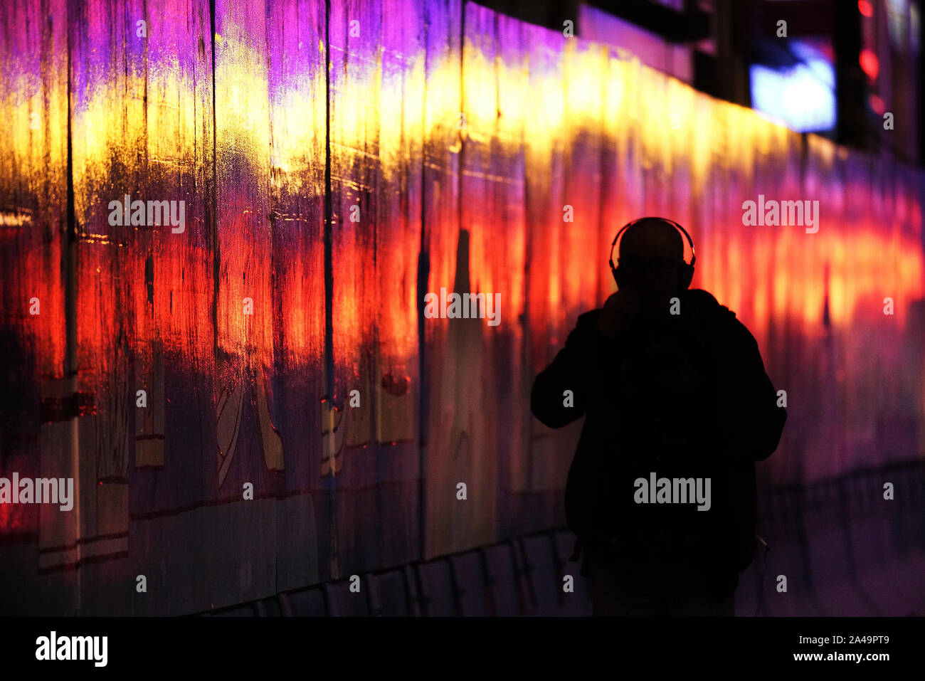 Montreal,Quebec,Canada,October 8,2019.Person walking along bright reflections at night in Montreal,Quebec,Canada.Credit:Mario Beauregard/Alamy News Stock Photo