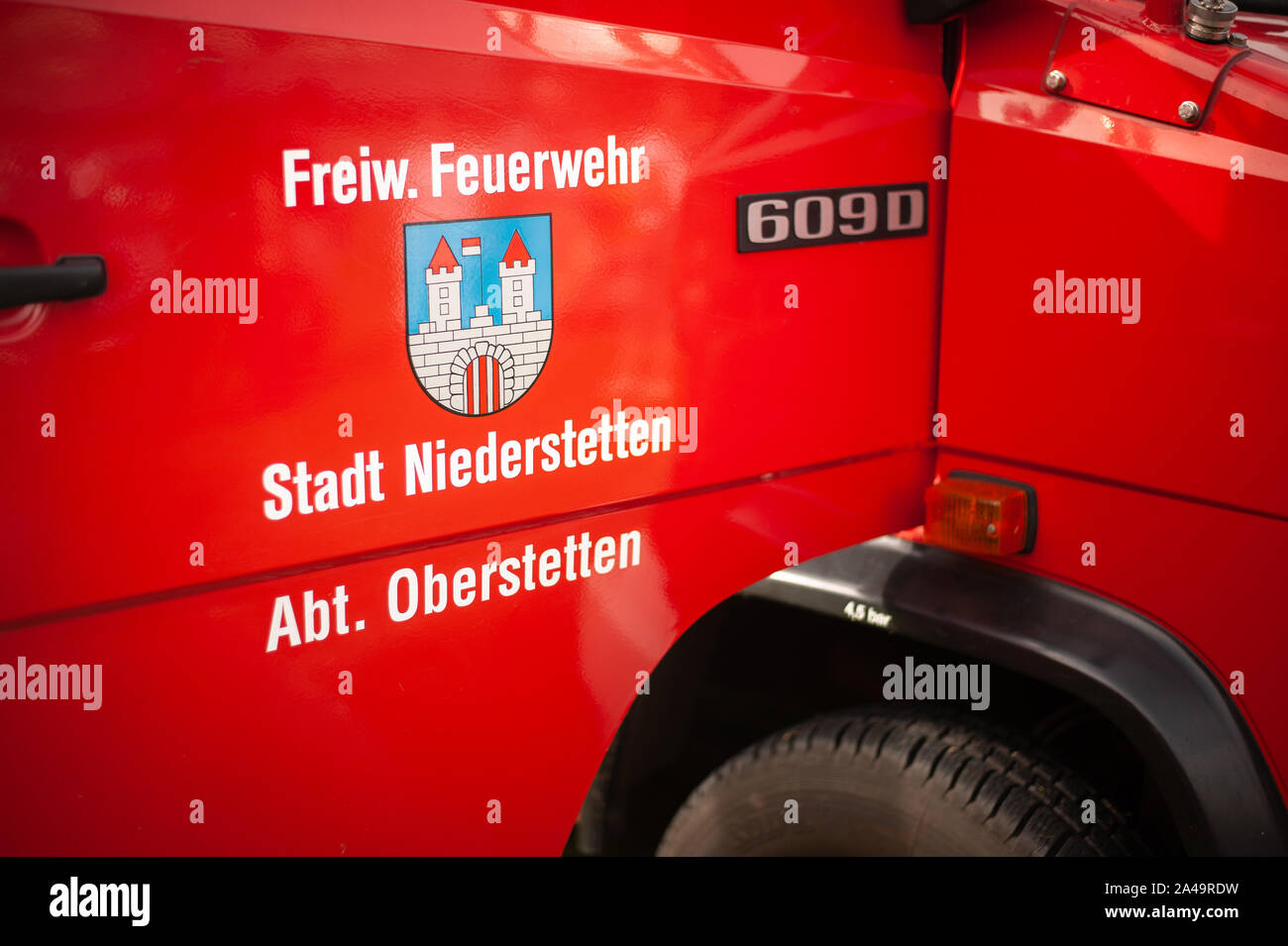 Germany, Baden Wurttemberg, Niederstetten. September 2019. Door of firefighters truck with text Freiw. Feuerwehr Stadt Niederstetten Abt. Oberstetten, Stock Photo