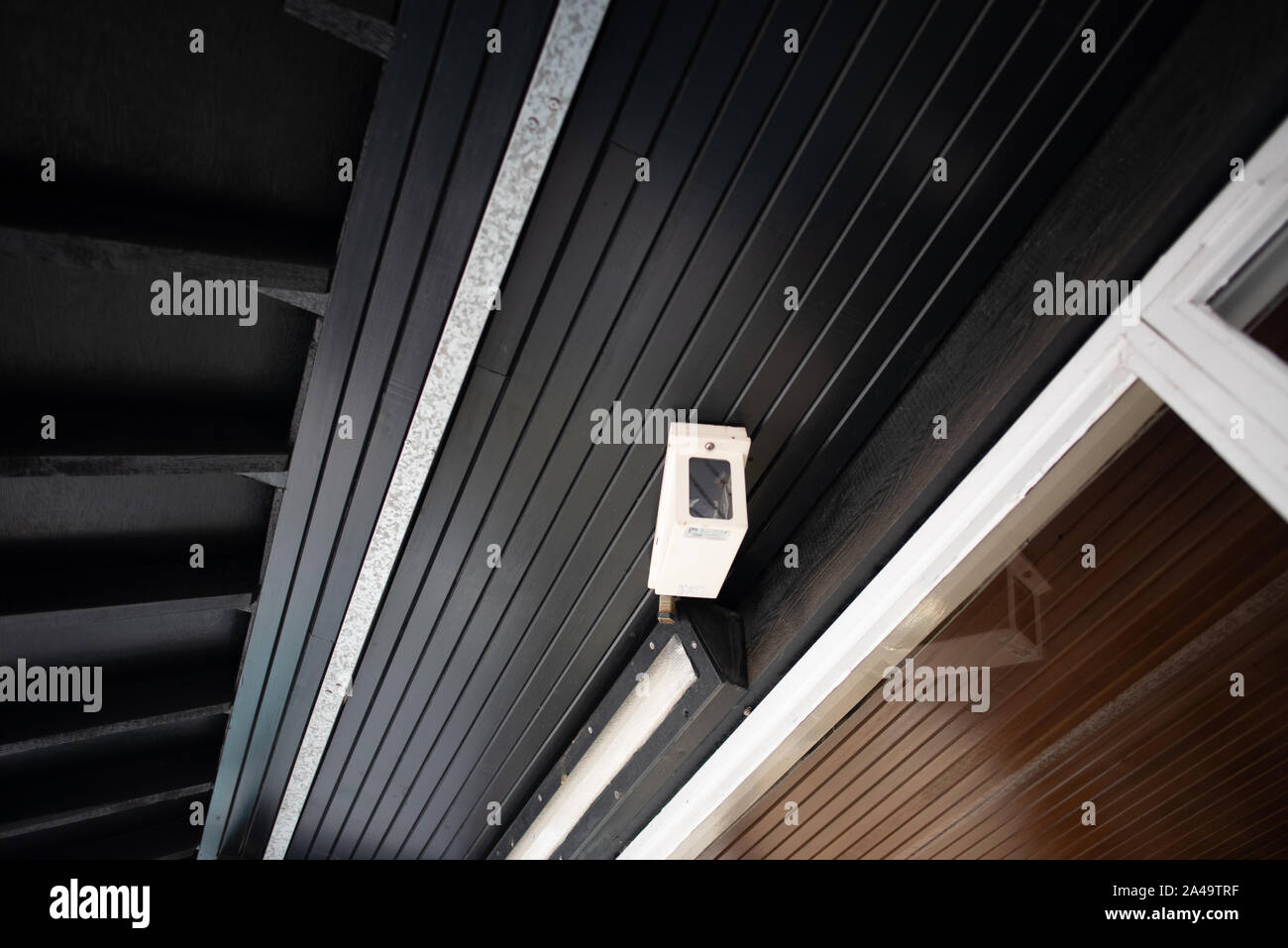 Kent, United Kingdom - September 15, 2019: A white closed circuit camera keeps an eye on travelers in the Knockholt Station waiting area on the Southe Stock Photo