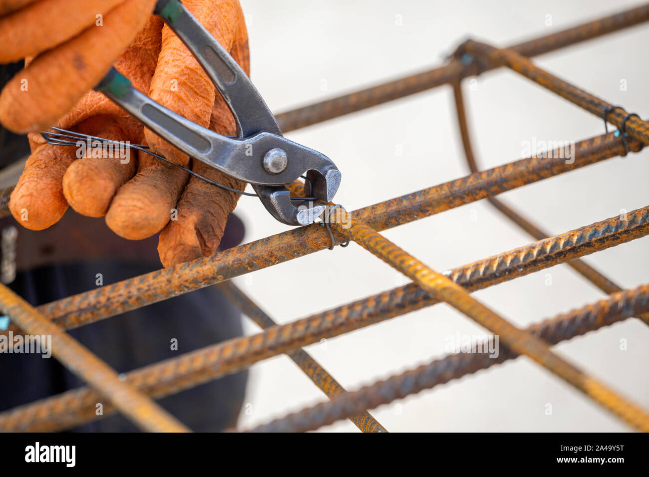 Tying reinforcing steel bars (rebar) for the construction. Tightening