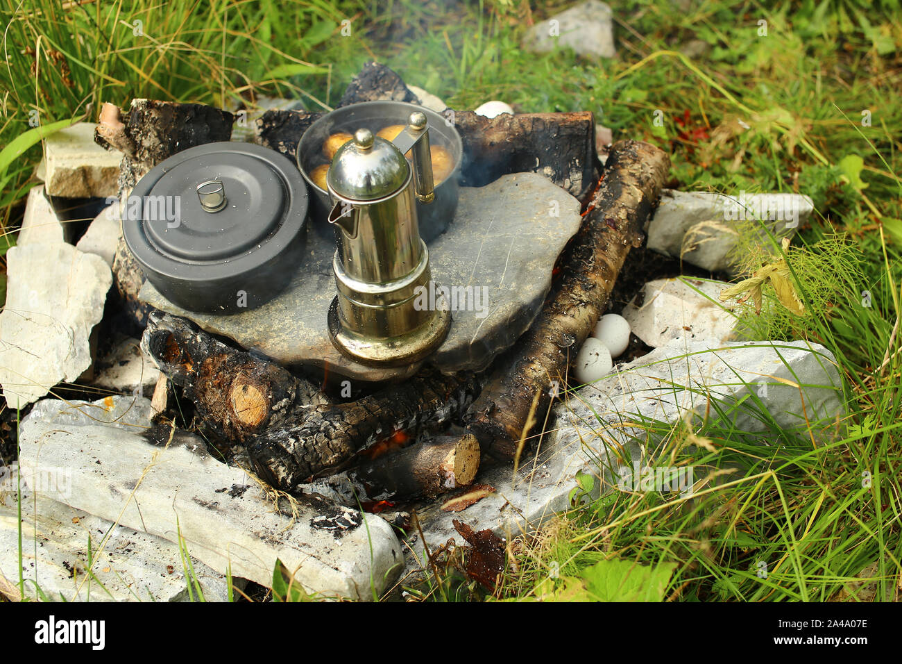 Improvised hot plate with several pots and coffee . Stock Photo