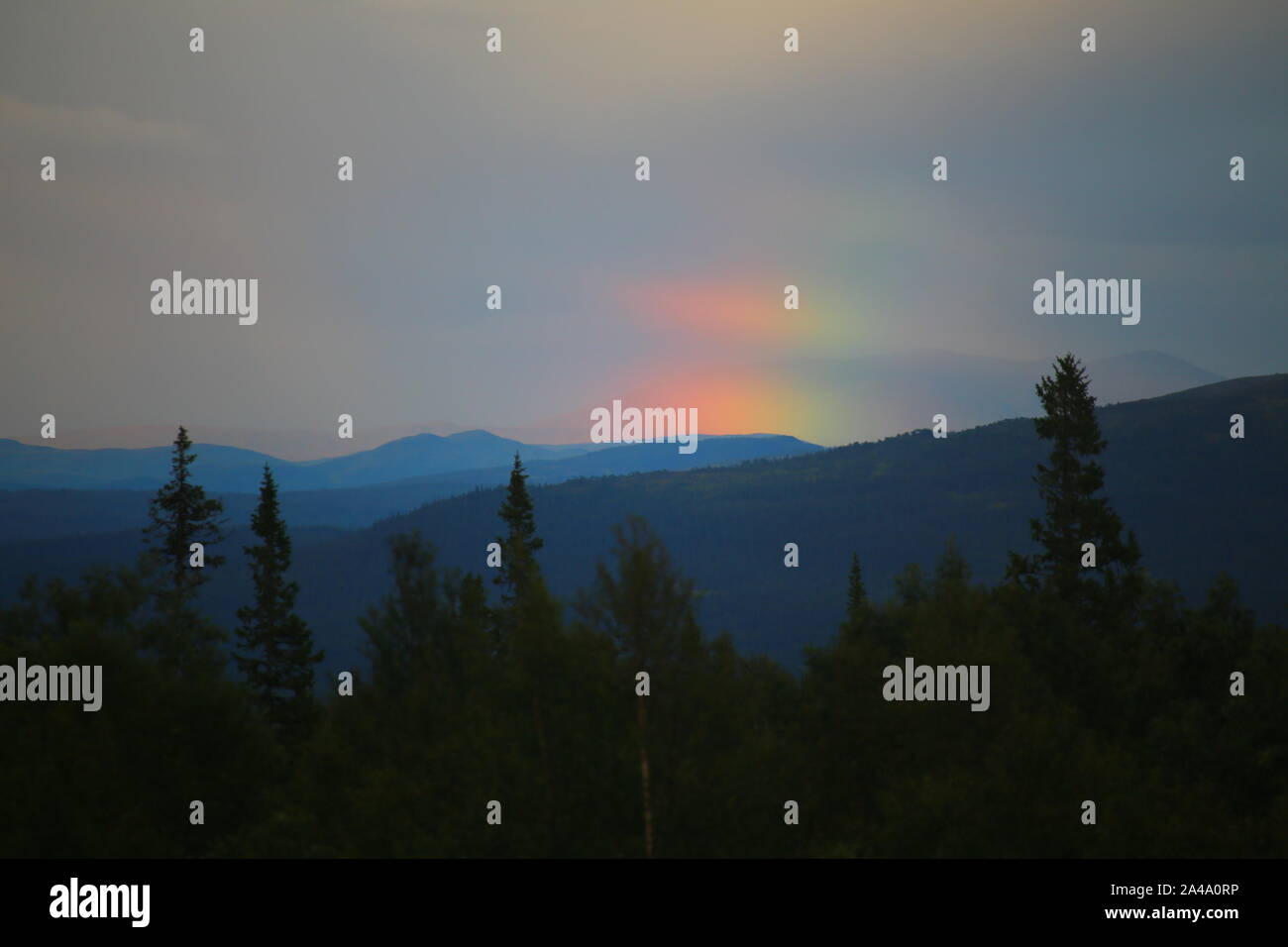 Blue mountaings and part of rainbow in the Swedish wilderness. Stock Photo