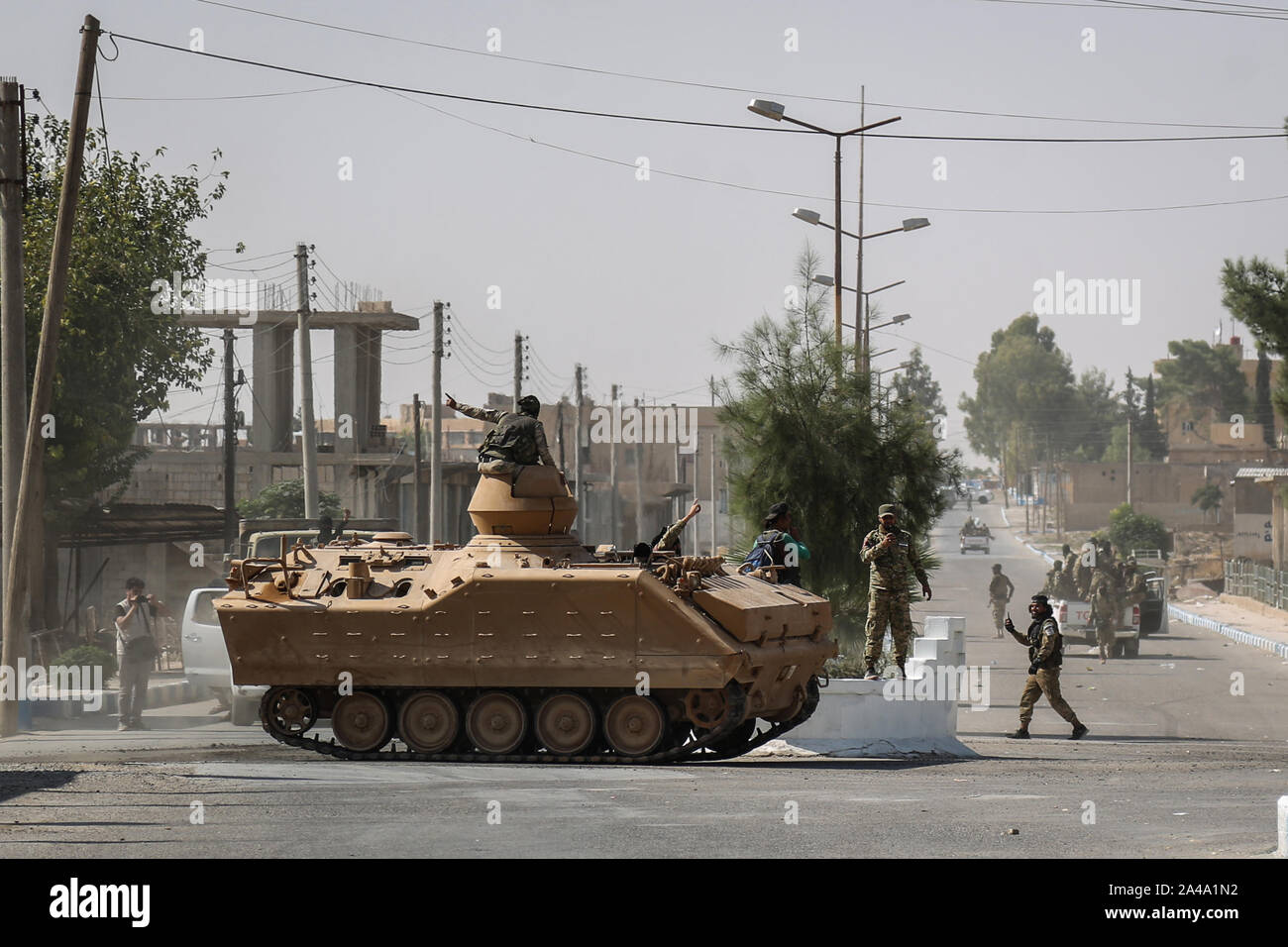 Tell Abiad, Syria. 13th Oct, 2019. Soldiers from the Turkish-backed Syrian National Army patrol a street at Suluk town in the countryside of Tell Abiad after clashes with Kurdish fighters. Credit: Anas Alkharboutli/dpa/Alamy Live News Stock Photo