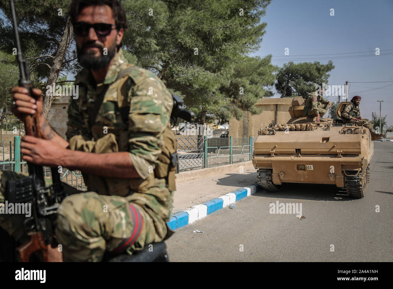 Tell Abiad, Syria. 13th Oct, 2019. Soldiers from the Turkish-backed Syrian National Army patrol a street at Suluk town in the countryside of Tell Abiad after clashes with Kurdish fighters. Credit: Anas Alkharboutli/dpa/Alamy Live News Stock Photo