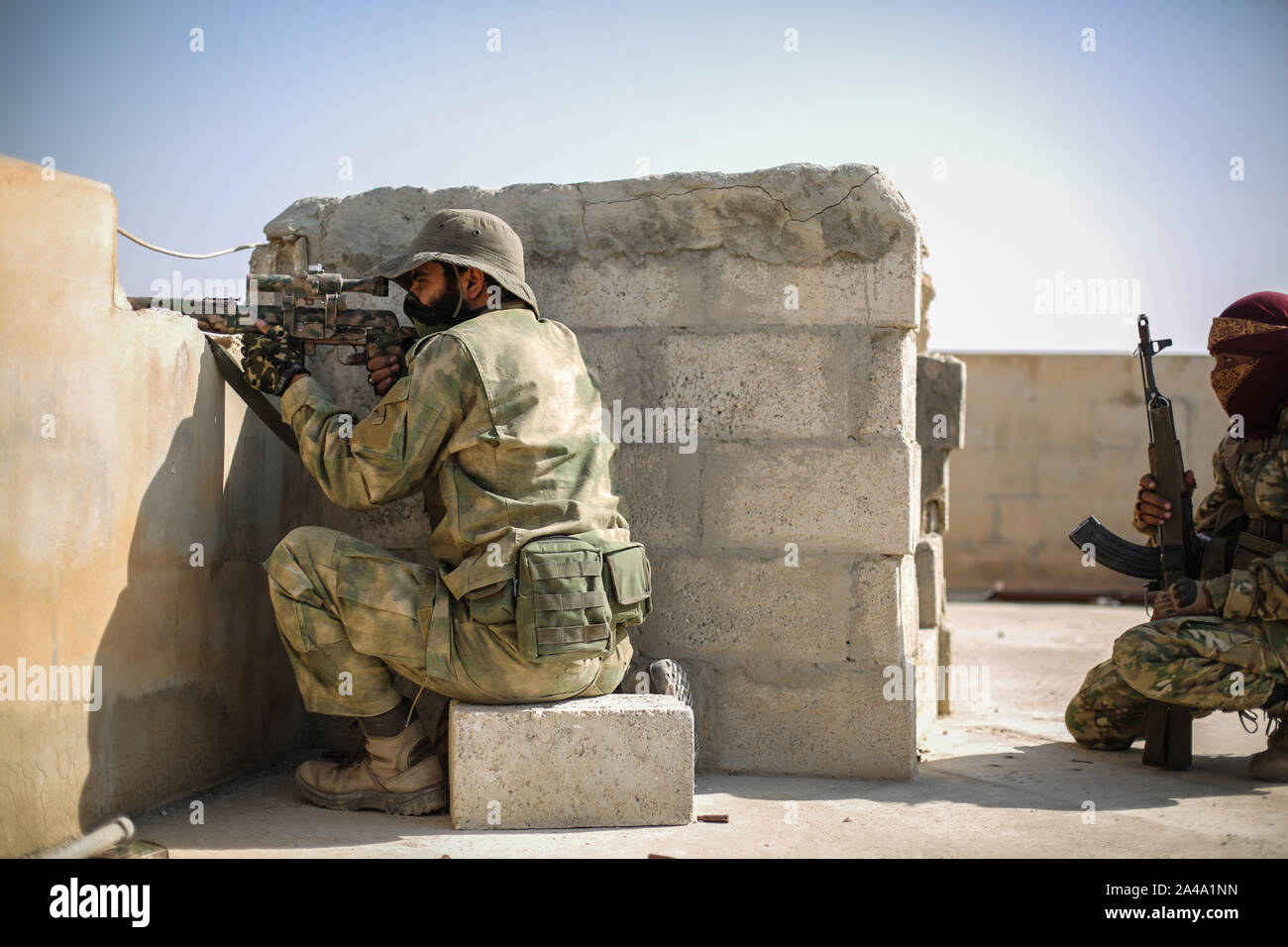 Tell Abiad, Syria. 13th Oct, 2019. A sniper from the Turkish-backed Syrian National Army takes aim on a rooftop at Suluk town in the countryside of Tell Abiad after clashes with Kurdish fighters. Credit: Anas Alkharboutli/dpa/Alamy Live News Stock Photo