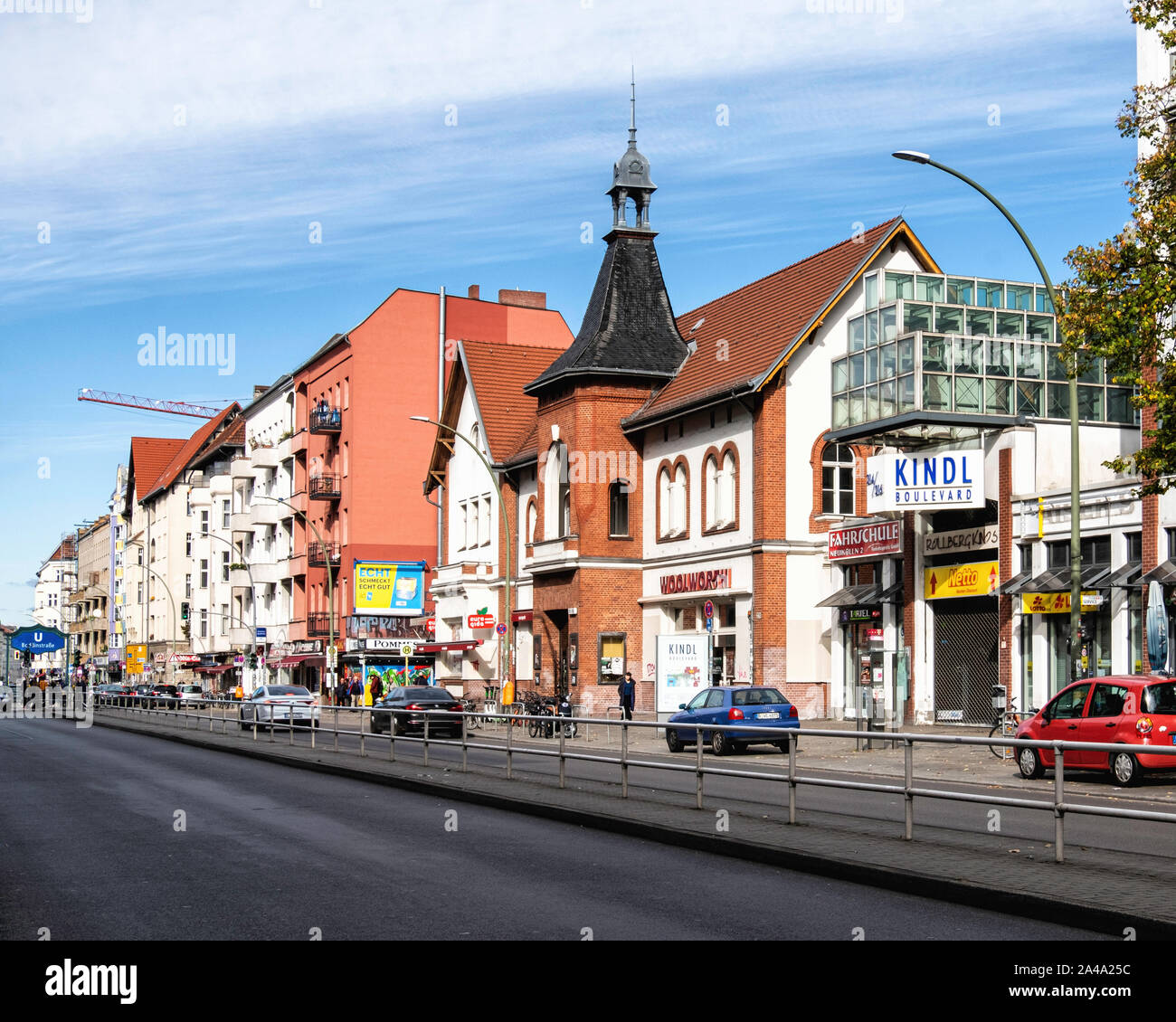 Hermannstrasse street view with shops & apartment buildings In Neukölln, Berlin. Kindl Boulevard, Woolwort store Stock Photo