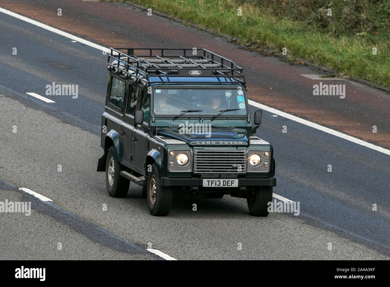 2013 green Land Rover Defender 110 XS TD D/C; traveling on the M6 motorway near Preston in Lancashire, UK Stock Photo