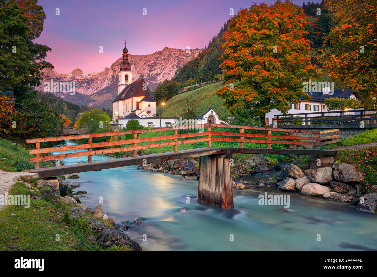 Autumn in Alps. Image of the Bavarian Alps with Parish Church of St. Sebastian located in Ramsau bei Berchestgaden, Germany during beautiful autumn su Stock Photo