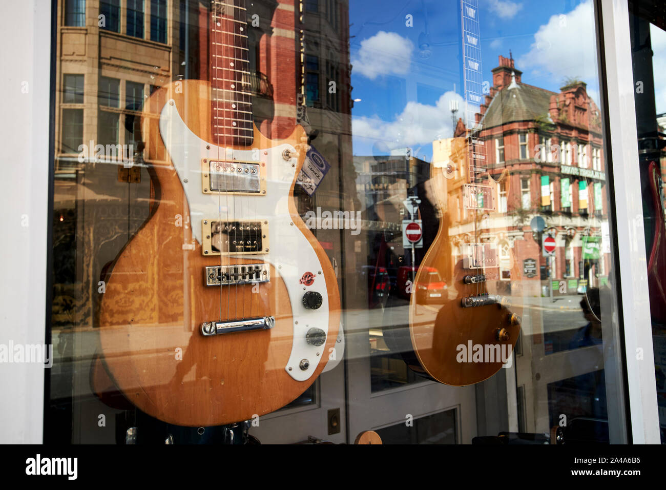 used electric guitars for sale in a music shop window display Liverpool England UK Stock Photo