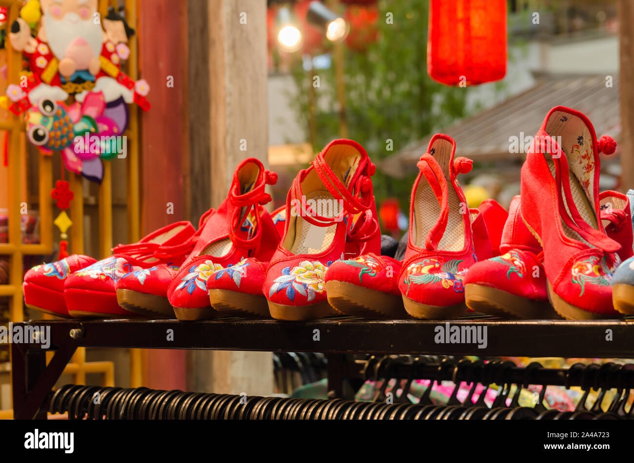 Traditional red Chinese embroidered shoes displayed in the store Stock Photo