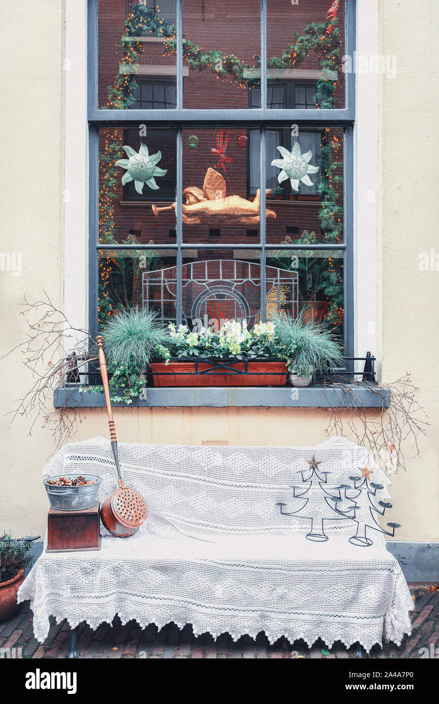 Decorated bench in front of the window for Christmas in Deventer in the Netherlands Stock Photo