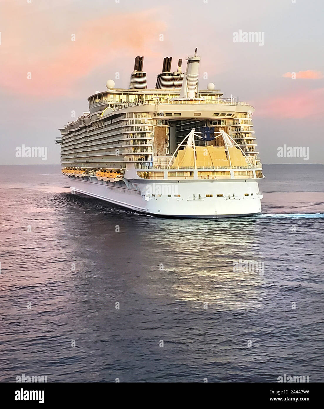 Large cruise ship turning around in preparation of docking Stock Photo