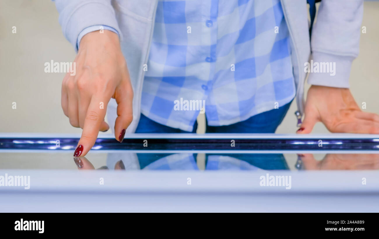Woman using interactive touchscreen display kiosk Stock Photo