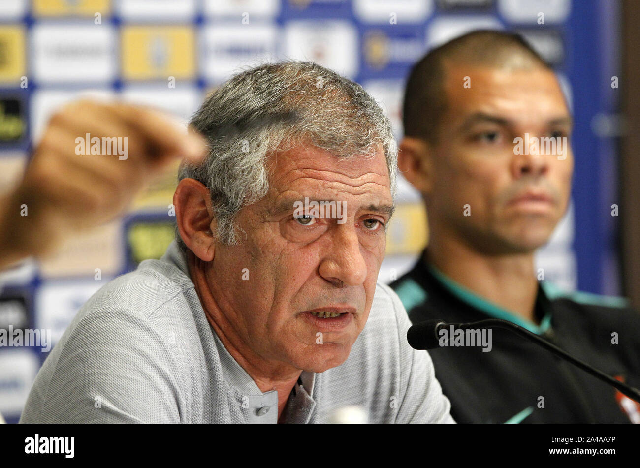 Kiev, Ukraine. 13th Oct, 2019. FERNANDO SANTOS (L), head coach of Portugal national team, and player PEPE (R) speak during a media conference at the Olimpiyskiy stadium in Kiev, Ukraine, 13 October 2019. Portugal will faces Ukraine in the UEFA Euro 2020 Qualifier Group B football match on 14 October. Credit: Serg Glovny/ZUMA Wire/Alamy Live News Stock Photo
