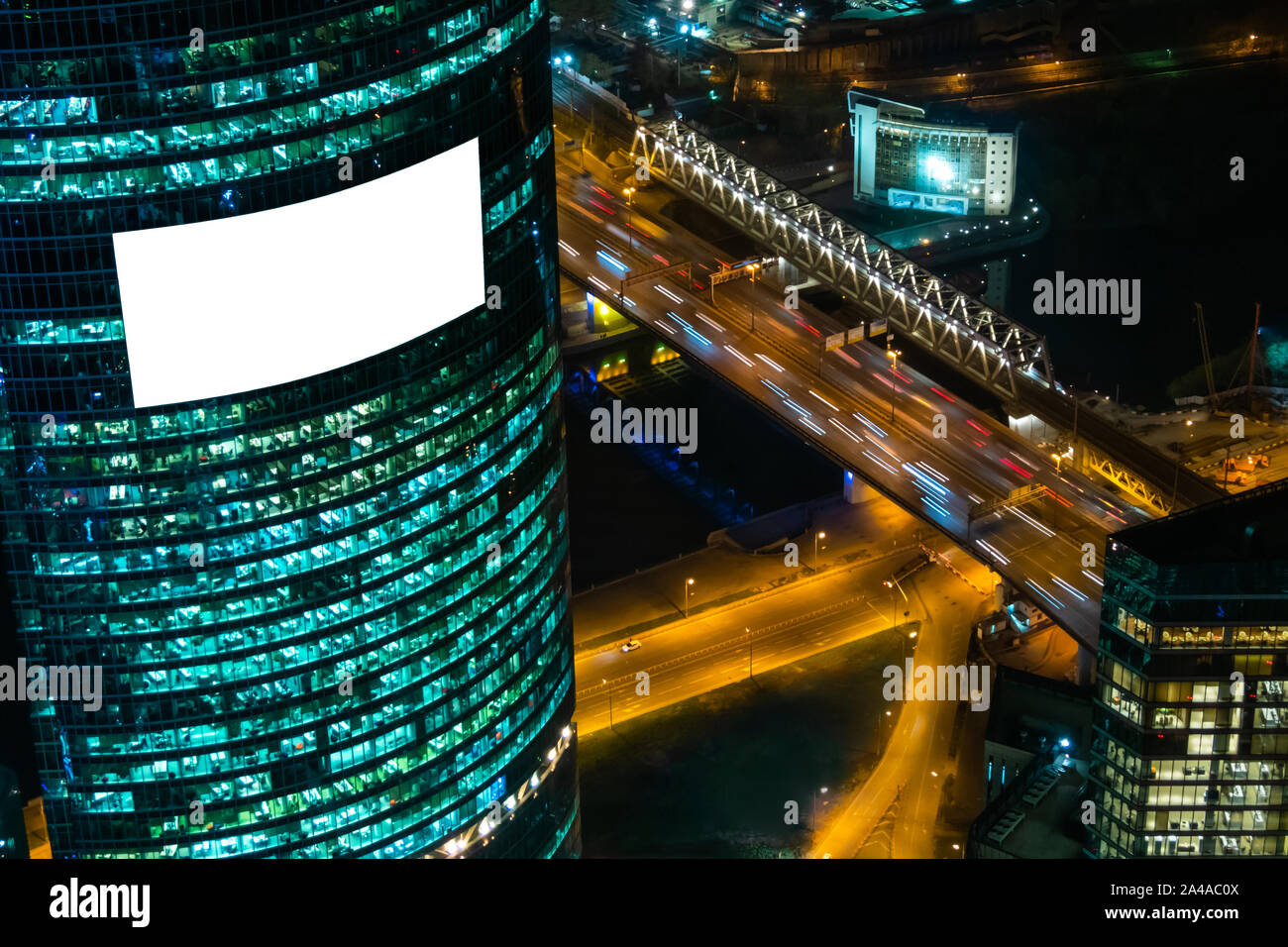 Blank isolated white screen billboard on building at night - mockup Stock Photo