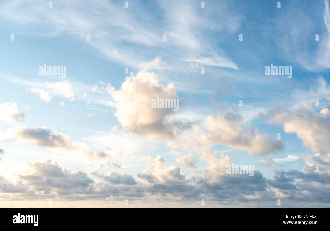 Blue sunset sky with many nice white clouds Stock Photo
