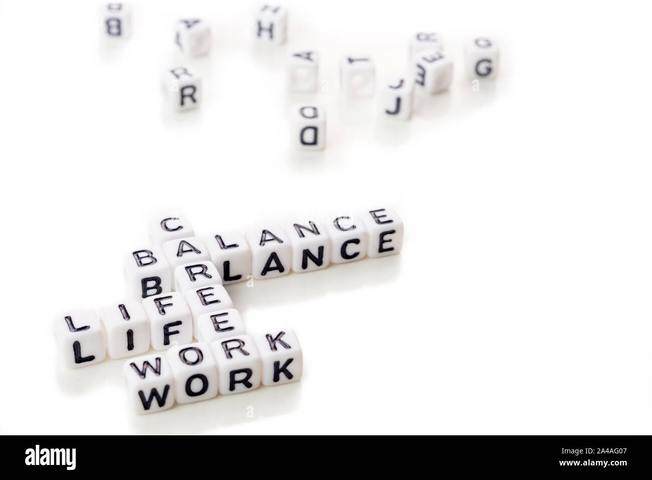 little white dices with black letters forming a crossword with the ...