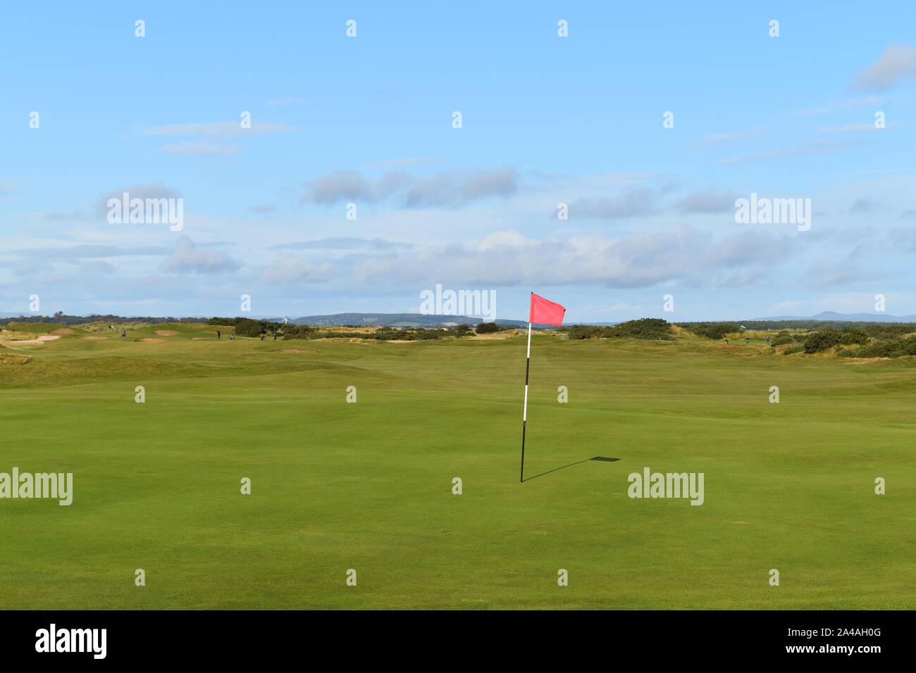Golf green at famous St Andrews Links Course in Scotland with flag blowing in breeze. Stock Photo