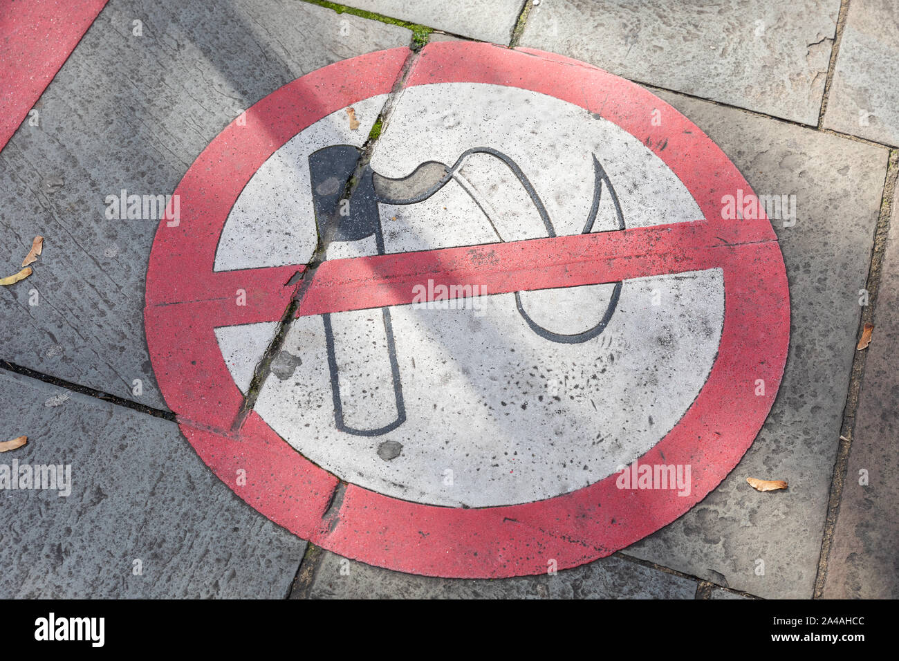 A no smoking sign painted on to the pavement of a private area on a city street Stock Photo