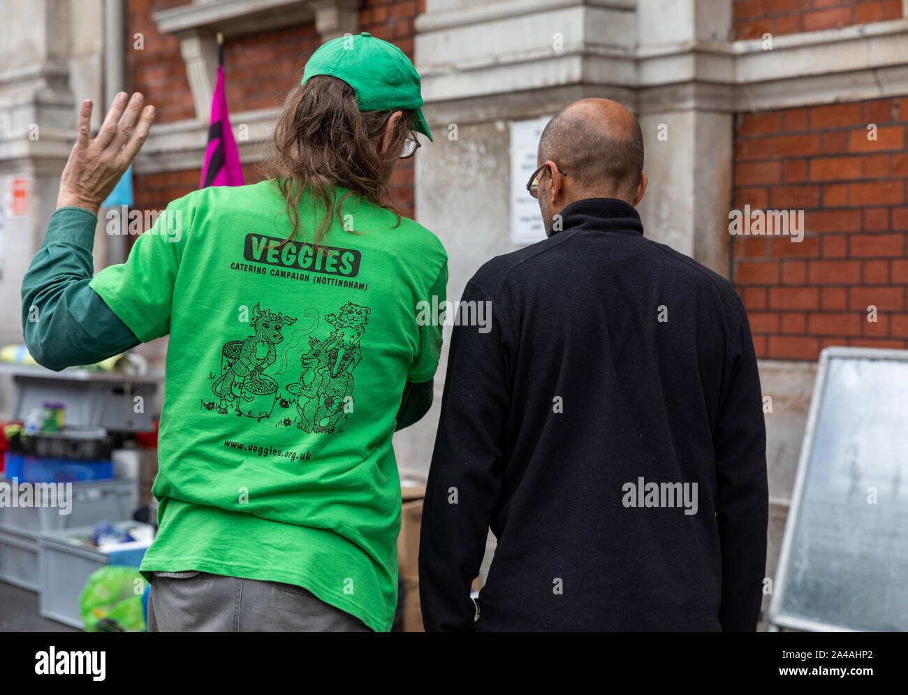 Two participants outside of Smithfields market organising the clear-up of gear after the Animal Rebellion protest on Monday 7th October 2019 Stock Photo