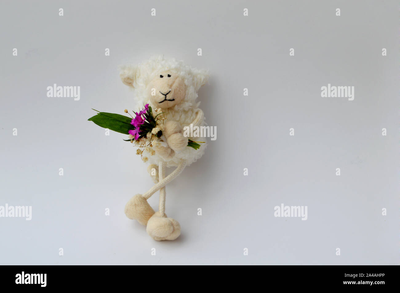 a funny sheep date waiting, sheep with bouquet of flowers Stock Photo